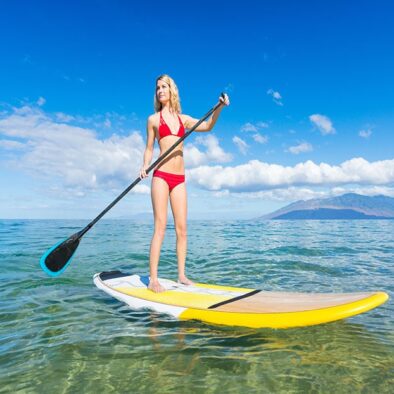 woman paddle baording in south maui mountains in background-min